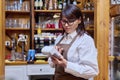 Woman worker manager of restaurant holding wireless banuov payment terminal