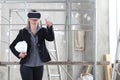 Woman architect or construction engineer wear virtual reality glasses and helmet and touch screen inside a building site with Royalty Free Stock Photo