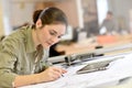 Woman architect drawing a plan at office