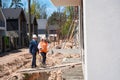 Woman architect welcoming male contractor, showing house under construction Royalty Free Stock Photo