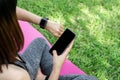 woman arm wearing smart watch and setting the program while doing yoga