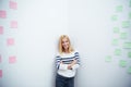 Woman with arms folded standing in corner at office Royalty Free Stock Photo