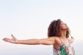 Woman with arms outstretched and her eyes closed outdoors Royalty Free Stock Photo