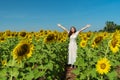 Woman with arms raised and enjoying with sunflower field Royalty Free Stock Photo