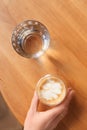 Woman with aromatic coffee at table in cafe