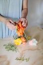 Woman arranges flowers for DIY terrarium