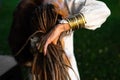 A woman arranges her dreadlocks