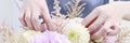 Woman arranging bouquet with pink peonies, roses and yellow dahlias Royalty Free Stock Photo