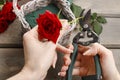 Woman arranging bouquet of red roses