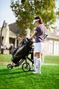 Woman arranging your golf equipment Royalty Free Stock Photo