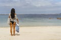 Woman arriving beach with towel, summer begins Royalty Free Stock Photo