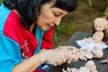 Woman artist make dolls of BJD or reborn in the workplace. Processing the workpiece. The concept of the craft of the master