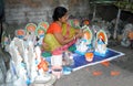 An woman artist making clay idols of Hindu Goddess.