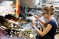 Woman artist making glass jewelry in her worksho