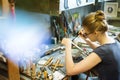 Woman artist making glass jewelry in her workshop Royalty Free Stock Photo