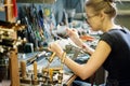 Woman artist making glass jewelry in her workshop