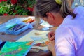 Woman artist painting with color pencils