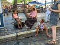 Woman artist paints young girl at Place du Tertre, Montmartre, Paris