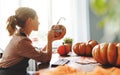 Woman artist prepares for halloween and paints pumpkins Royalty Free Stock Photo