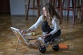 Woman artist sits on the floor in a dark art studio Royalty Free Stock Photo