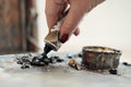 A woman artist squeezes oil paint onto a palette from a tube. Royalty Free Stock Photo