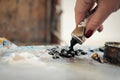 A woman artist squeezes oil paint onto a palette from a tube. Royalty Free Stock Photo