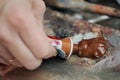 A woman artist squeezes oil paint onto a palette from a tube. Royalty Free Stock Photo