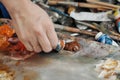 A woman artist squeezes oil paint onto a palette from a tube. Royalty Free Stock Photo