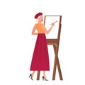 Woman artist standing at the easel and painting