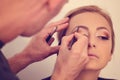 Woman in artist studio geting make up on