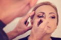 Woman in artist studio geting make up on