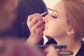 Woman in artist studio geting make up on