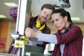 woman as carpenter trainee learning how to measure