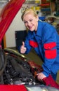 Woman as a mechanic in car workshop Royalty Free Stock Photo