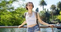 Woman as a tourist stands in front of lake Parc de la Ciutadella in Barcelona, Spain