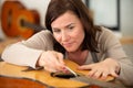 woman as trainee fixing guitar Royalty Free Stock Photo