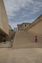 Woman ascending steps near a large building in La Valletta, Malta