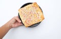 woman asian hand holding a Appetizing Homemade pizza bread with ketchup, mayonnaise, boiled corn sausage and cheese Royalty Free Stock Photo