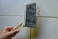 Woman asian or housekeeper sweeping tiled floor with plastic whisk broom and dustpan indoors.close up. Royalty Free Stock Photo