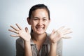 Woman asian smiling with open palms.