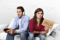 Woman asking for help angry upset while husband or boyfriend plays videogames ignoring her