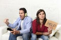 Woman asking for help angry upset while husband or boyfriend plays videogames ignoring her