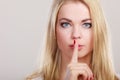 Woman asking for silence finger on lips hush hand gesture. Royalty Free Stock Photo