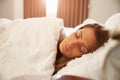 Woman Asleep In Bed As Sunlight Comes Through Curtains Royalty Free Stock Photo