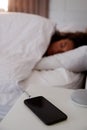 Woman Asleep In Bed With Mobile Phone On Bedside Table Royalty Free Stock Photo