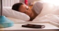 Woman Asleep In Bed Using Alarm On Mobile Phone Royalty Free Stock Photo