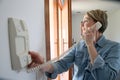 Woman asnwering intercom