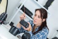Woman assembling camera parts Royalty Free Stock Photo