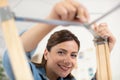 woman assembling furniture in new house