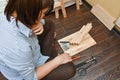 Woman is assembling wooden furniture with tools during quarantine isolation Royalty Free Stock Photo